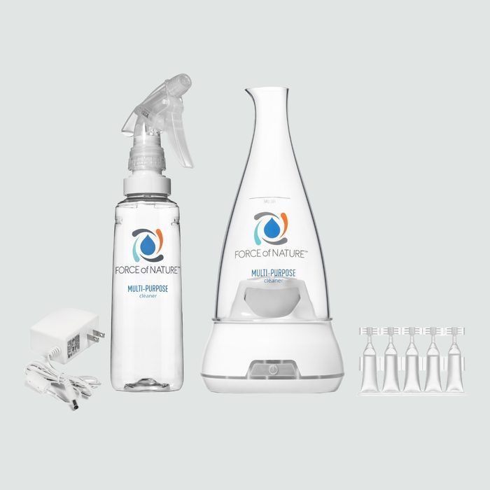 Cleaner spray bottle and generator stand side-by-side, with a charger and capsules, labeled 