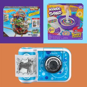 Hot Wheels Ultimate Garage box atop purple, Kinetic Sand Deluxe Swirl N' Surprise set on blue, VTech Kidizoom PrintCam with printed dog image on orange.