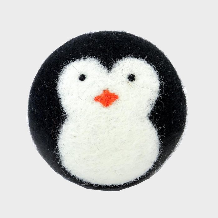 Penguin-shaped felt ball sits against a plain white background, featuring black outer layer, white face, and orange beak.