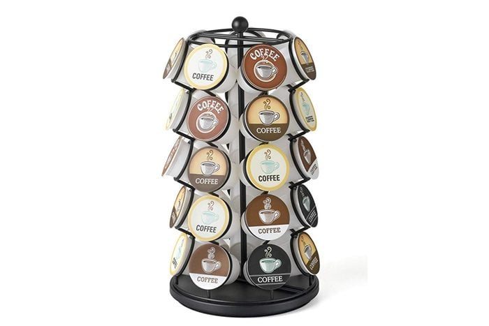 A rotating stand holds various coffee pods labeled 