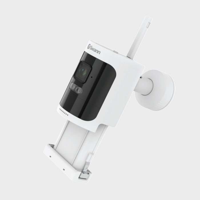 Security camera mounted on a wall bracket, displaying a lens and sensors, with branding 