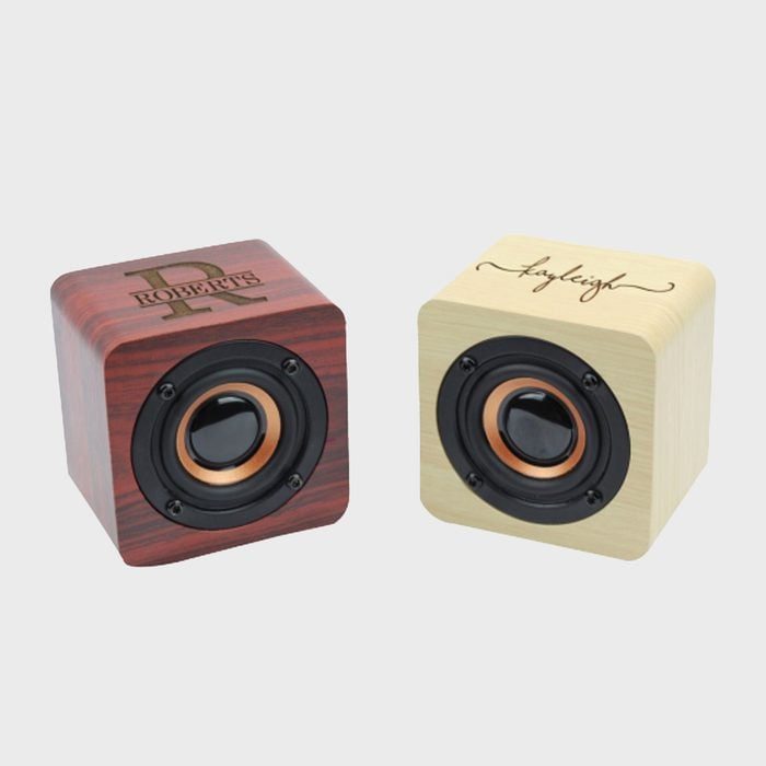 Two cube-shaped wooden speakers with engraved names 