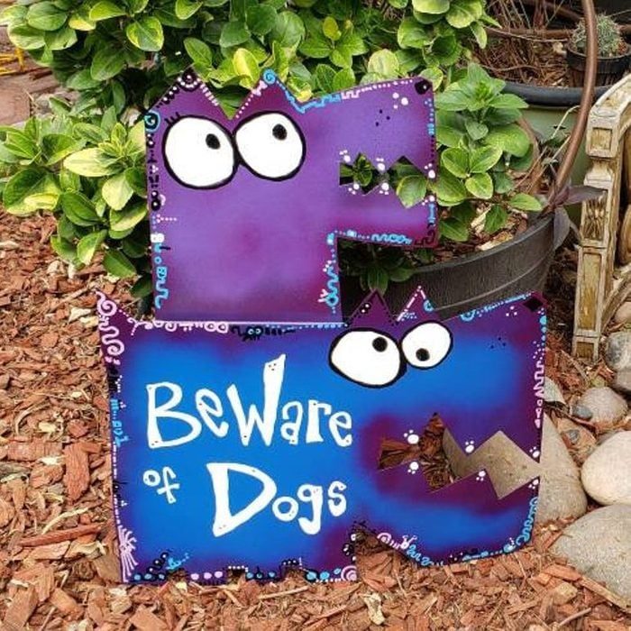 A purple, cartoon dog-shaped sign displays 