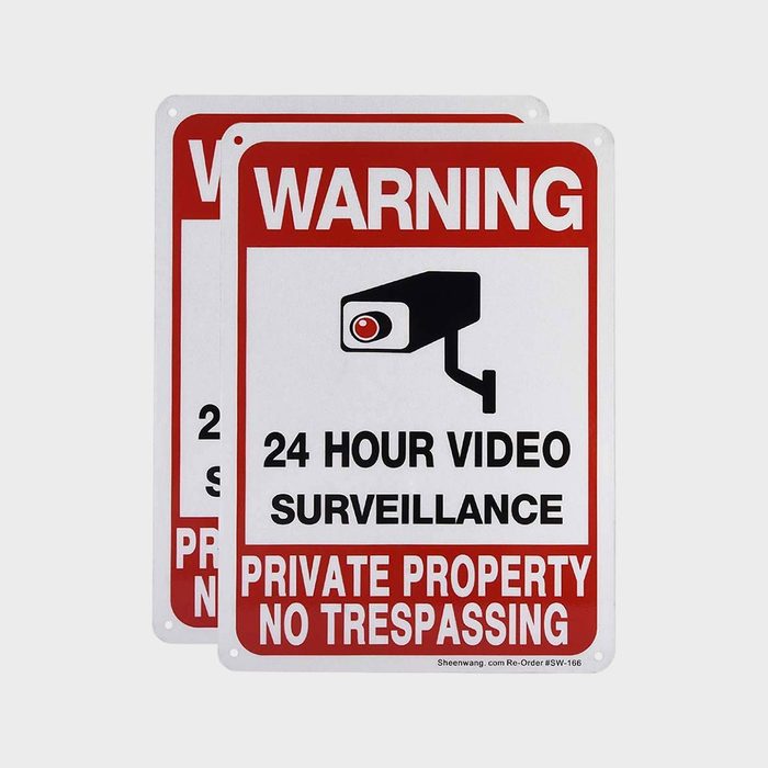 Sign warns of constant video surveillance, with bold text and a camera icon, indicating private property and no trespassing.