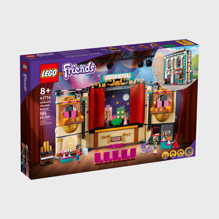LEGO set box displaying a detailed theater with figures performing on stage, surrounded by colorful curtains and decorative elements.