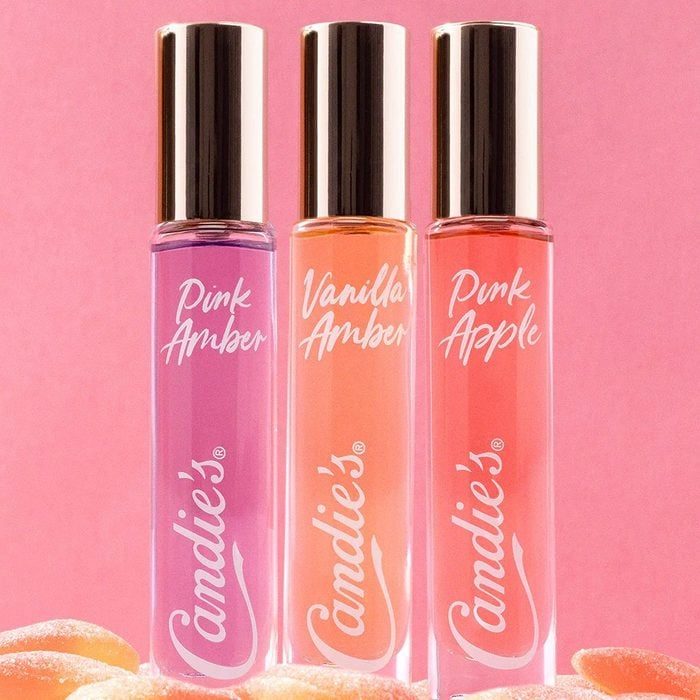 Three perfume bottles stand upright, labeled 