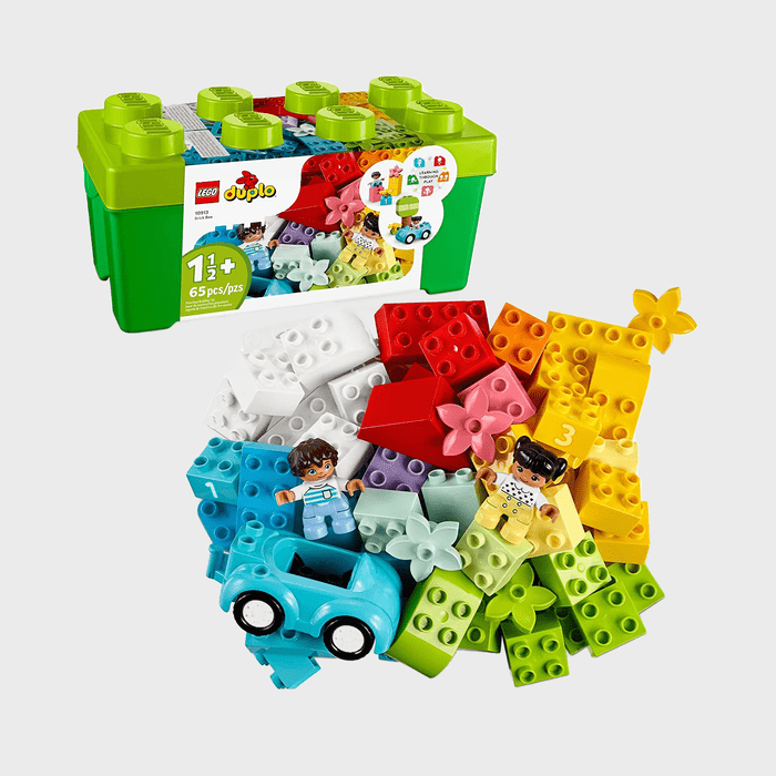 Lego Duplo pieces scatter vibrantly, featuring figures and a toy car, accompanied by a green storage box labeled 