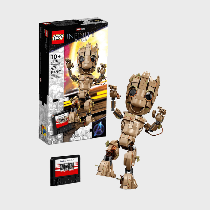 Lego Groot character stands joyfully near packaging, displaying 