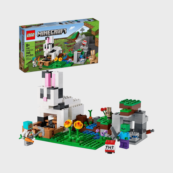LEGO set displays a bunny-like building with characters and plants, set in a grassy Minecraft-themed environment. Box features 