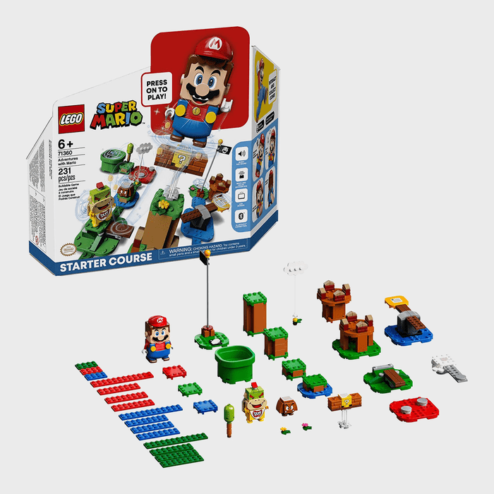 LEGO Mario figure stands among assembled blocks; green pipes, platforms, and decorations mimic a pixelated landscape. Box has 