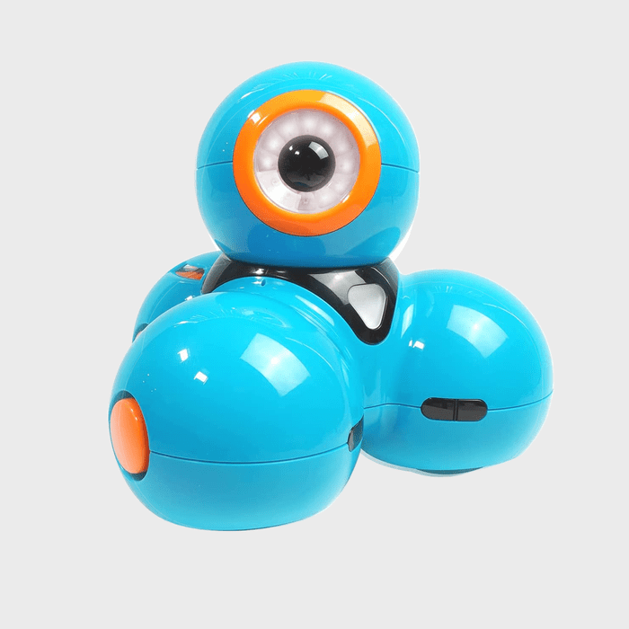 A blue robotic toy sits on a neutral background, featuring a large eye-like design and spherical shapes with orange accents.