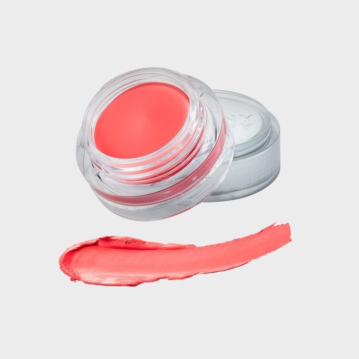 A clear container holds coral lip balm; below, a smooth coral swatch lies on a white background.