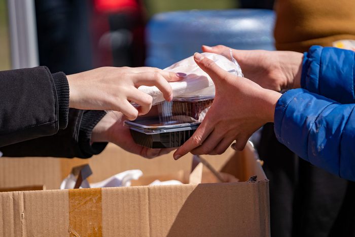 person handing food to another