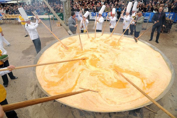 Members of the Giant Omelette Brotherhood of Bessieres cook a giant omelette as part of Easter celebrations