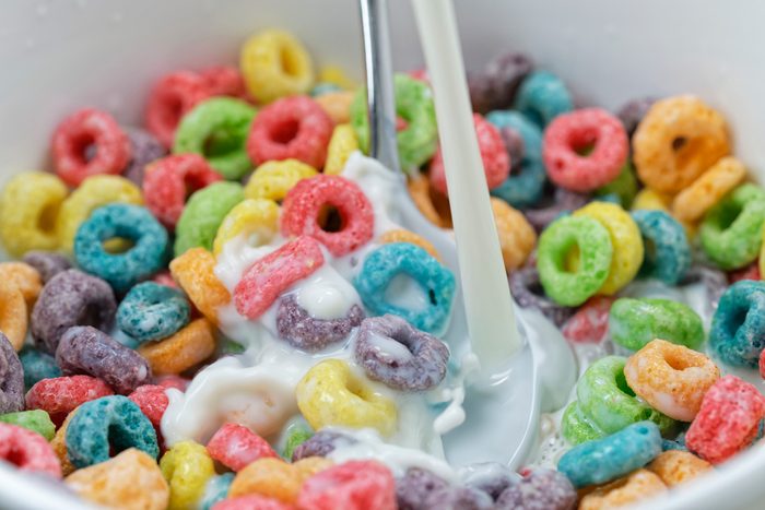 milk being poured into cereal