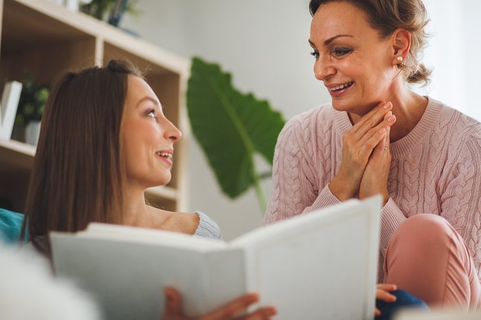 mother and daughter looking at a photo album