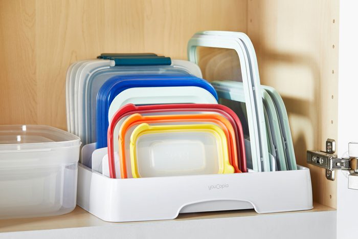 food container lid organizer in an open kitchen cabinet