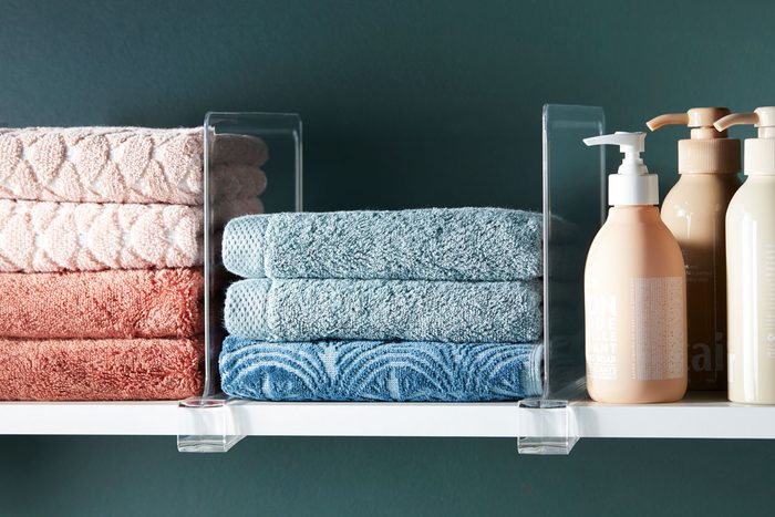 shelf dividers creating division between sections of items on a shelf