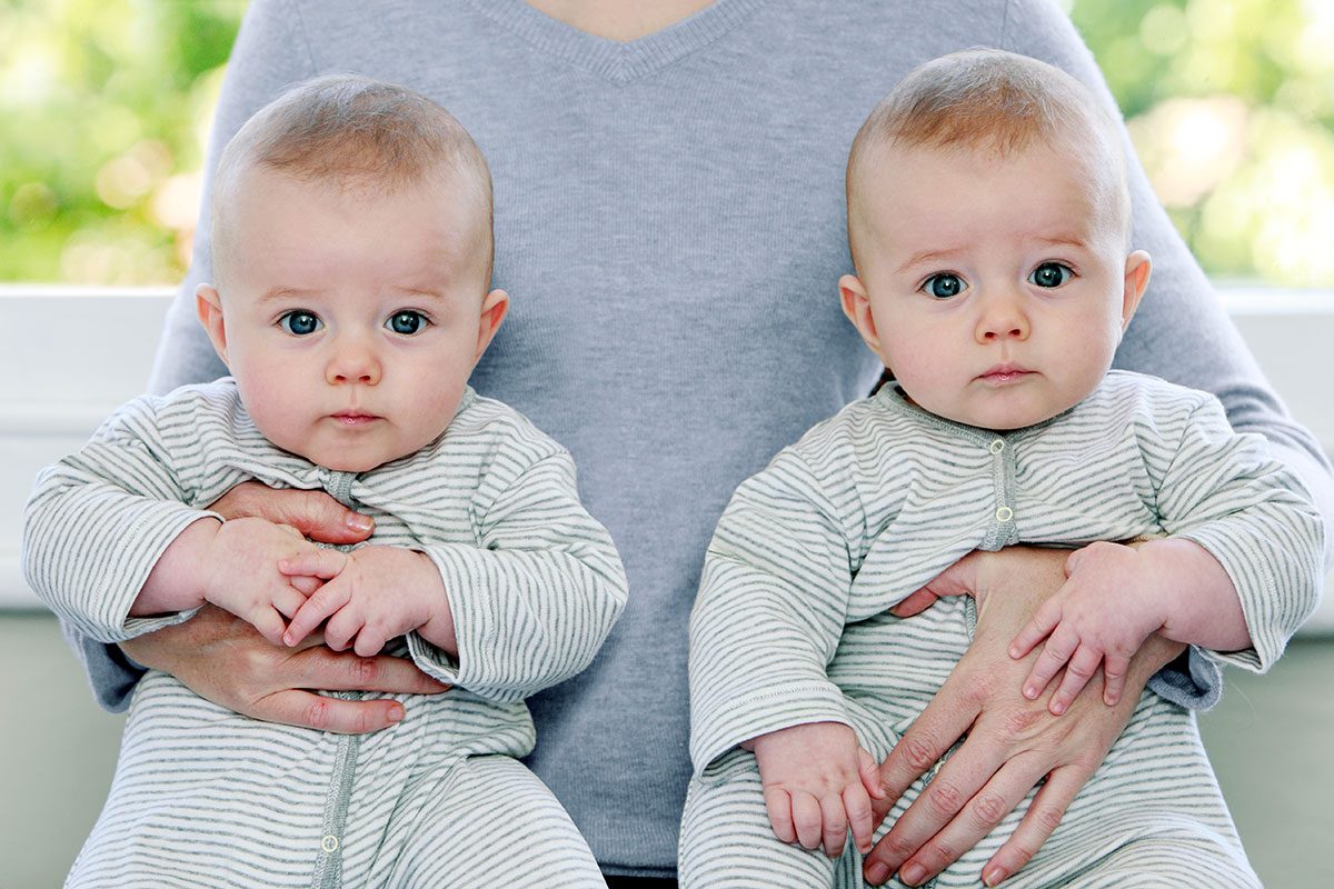 Mother holding twin baby boys